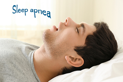 Conceptual image of a sleeping man with "sleep apnea" text symbolizing breathing disorder